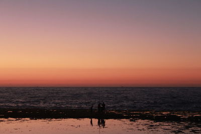 Scenic view of sea against clear sky during sunset