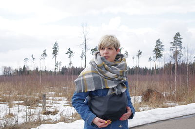 Full length of teenage girl standing on snow covered land