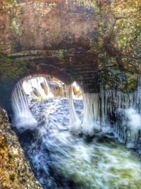 Scenic view of river flowing through rocks