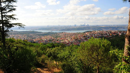 High angle view of cityscape by sea against sky