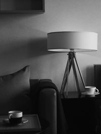 Coffee cups on table with lamp at home