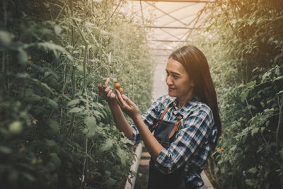 Young woman looking at plants