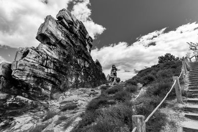 Low angle view of rock formation on mountain against sky