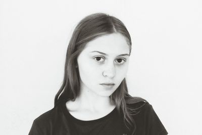 Portrait of young woman against white background