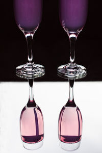 Close-up of wineglass on table against black background