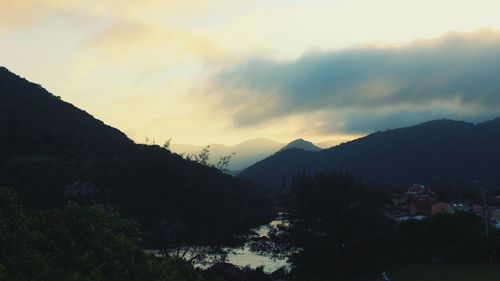 Scenic view of mountains against sky at sunset