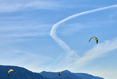 People paragliding against sky