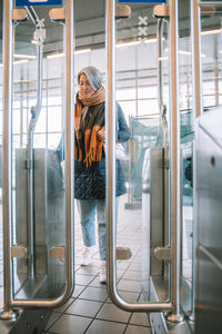 Full length of woman entering in train station