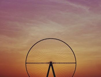 Low angle view of silhouette ferris wheel against sky at sunset