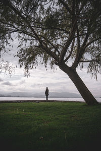 Man standing on field against sky