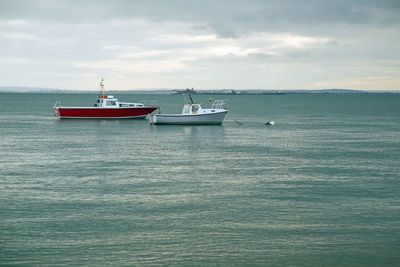 Boat sailing in sea against sky