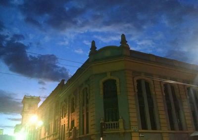 Low angle view of building against cloudy sky