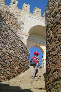 Female traveler climbing the staircase of rabati fortress complex, akhaltsikhe city, georgia