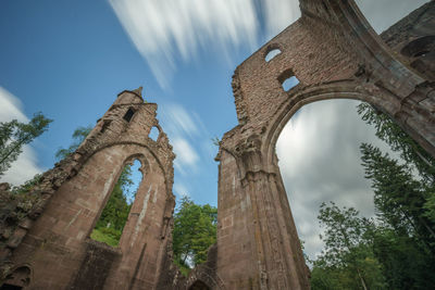 Low angle view of old building against cloudy sky