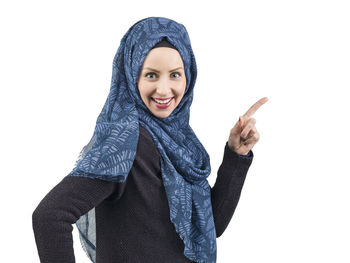 Portrait of smiling young woman against white background