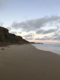 Scenic view of beach against sky during sunset