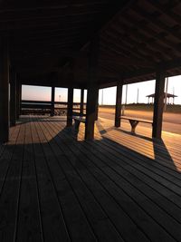 View of pier on beach during sunset