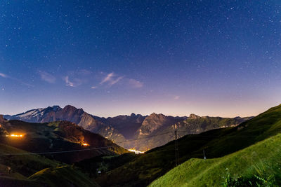 Scenic view of mountains against sky at night