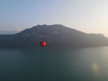 Red lake against mountain range