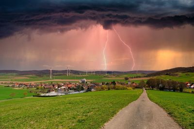 Panoramic view of lightning over field