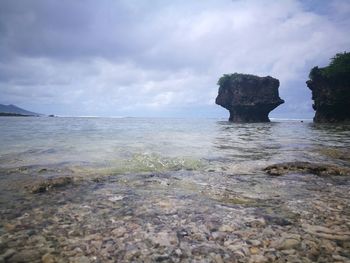 Rocks on beach against sky