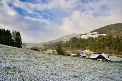 Scenic view of landscape and houses against sky