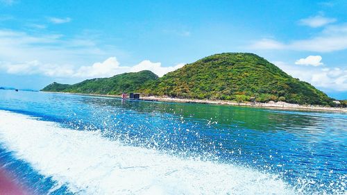 People on beach by sea against sky