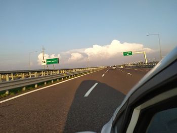 Road sign against sky