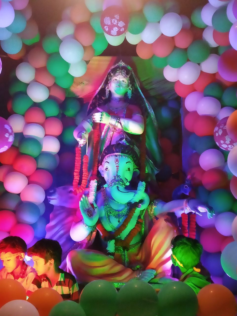 HIGH ANGLE VIEW OF ILLUMINATED SCULPTURE IN TEMPLE