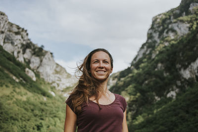 Portrait of a smiling young woman standing outdoors