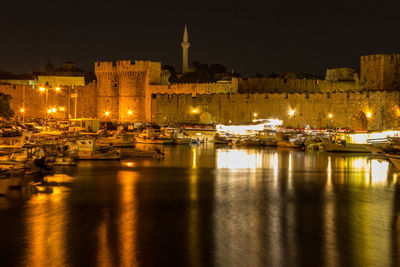 Sailboats in city at night