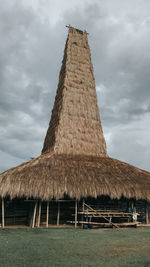 Low angle view of building against cloudy sky