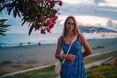 Young woman standing at beach