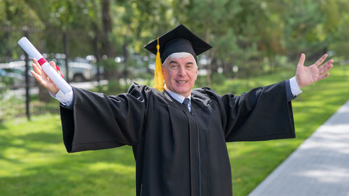 Rear view of woman wearing graduation gown