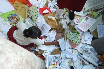 High angle view of a girl collecting books