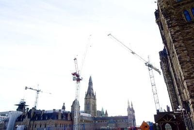 Low angle view of amusement park in city