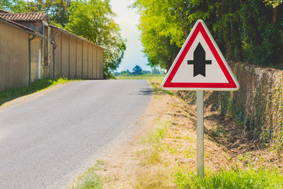 Road sign by trees