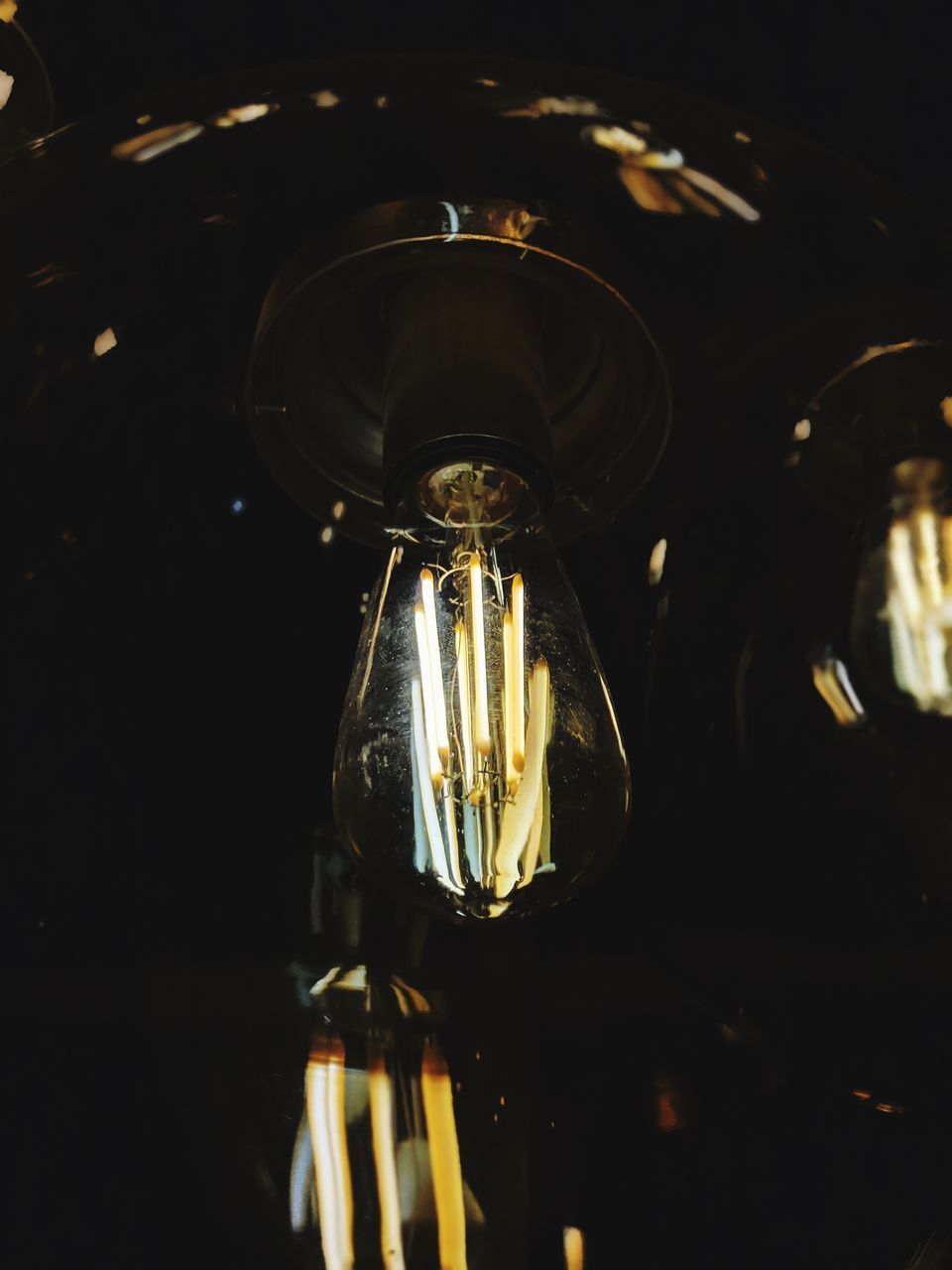 LOW ANGLE VIEW OF ILLUMINATED LIGHT BULBS