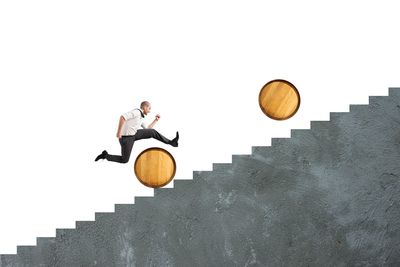 Low angle view of man walking on staircase against sky