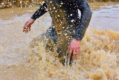 Man splashing water in sea