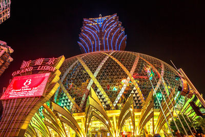 Low angle view of illuminated ferris wheel against sky at night