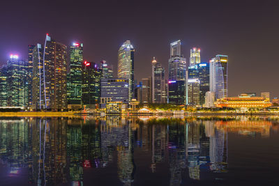 Illuminated buildings against sky at night