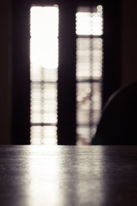 Defocused image of building seen through window