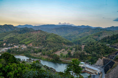 High angle view of lake and mountains against sky