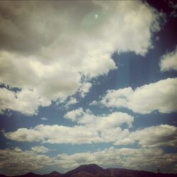 Scenic view of landscape against cloudy sky