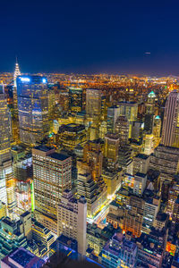 High angle view of illuminated cityscape against sky at night