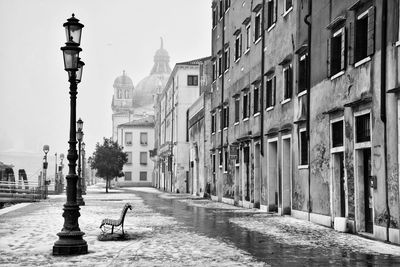 Street amidst buildings against sky in city