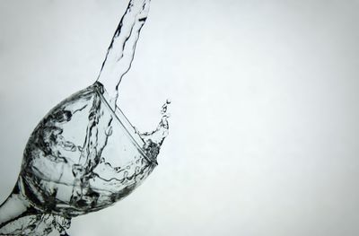 Close-up of glass of water against white background