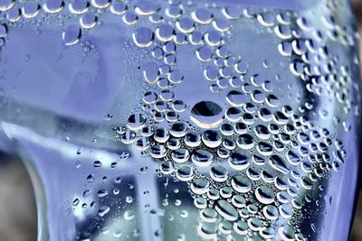 Close-up of water drops on metal
