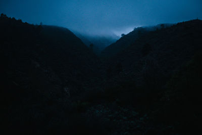 Scenic view of mountains against sky at night